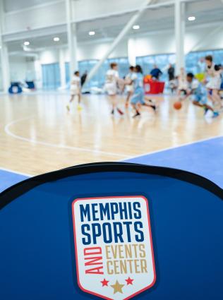 Memphis Sports and Event Center logo with youth basketball game in background at the new Liberty Park Memphis