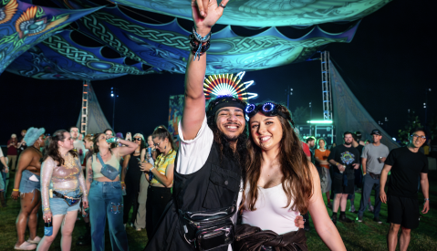 two people pose for photo at night during riverbeat