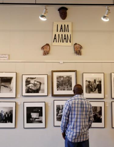 Man looking at photographs at the Withers Collection Museum & Gallery.