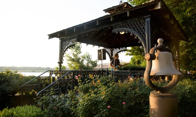 A bell and metal gazebo overlooking Mississippi River at Metal Museum.
