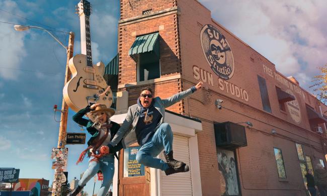 Couple jumps in front of Sun Studio