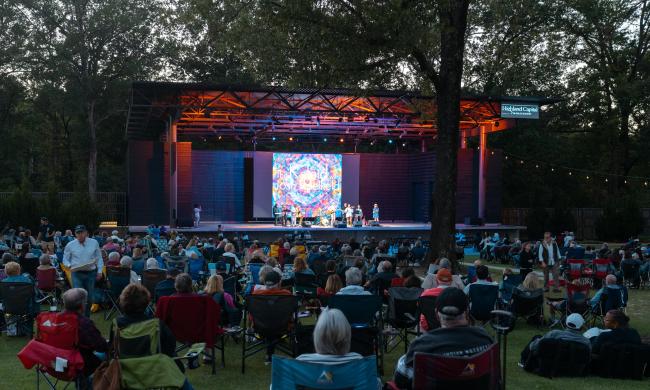 People sitting in lawn chairs watching a band at The Grove at GPAC concert venue.
