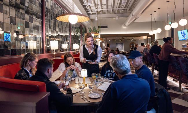 A group placing orders with a waitress inside Felicia Suzanne's