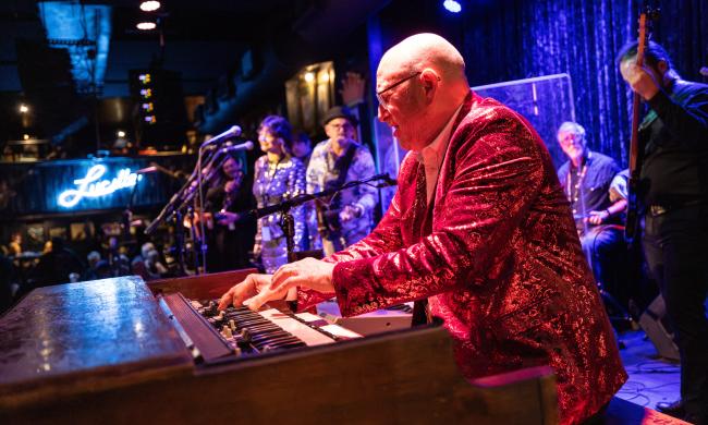 Man in red sequin blazer plays piano at B.B. King's Blues Club during International Blues Challenge