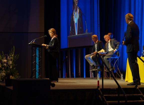 Woman honoree speaks on stage at MSHOF