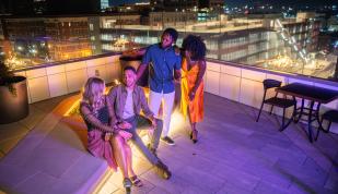 friends gathering around rooftop fire pit
