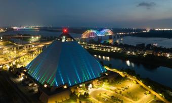 Aerial night view of the Bass Pro Pyramid, Mighty Lights bridge and Mississippi River.